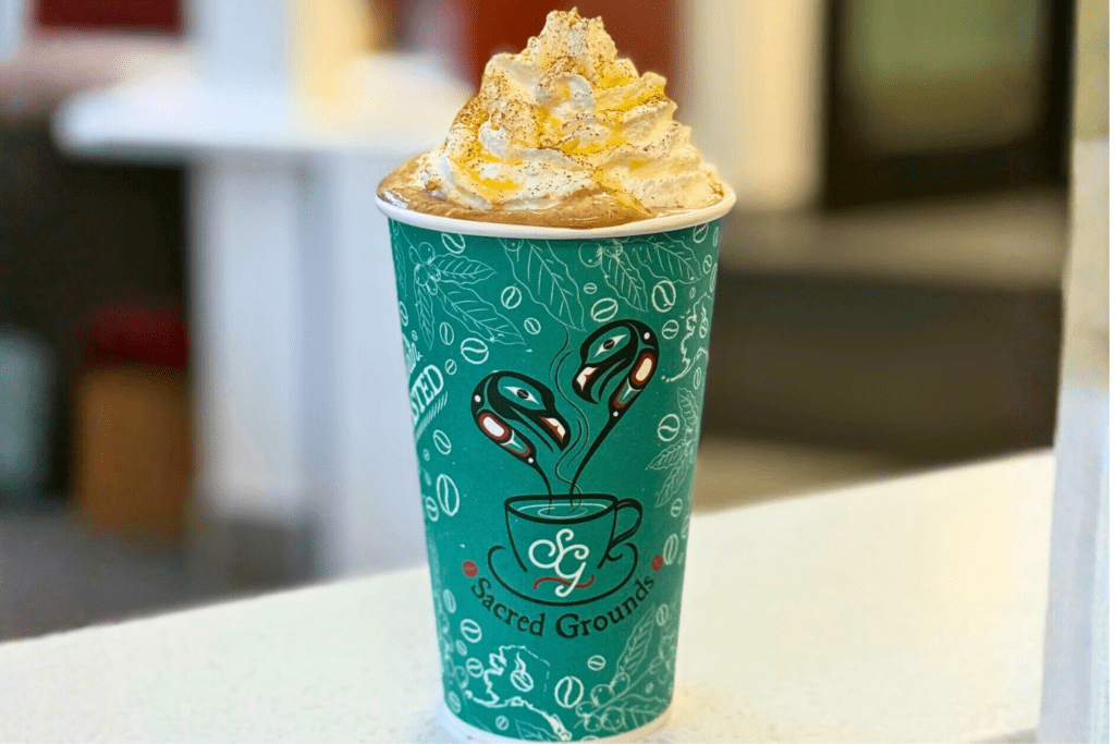Hot coffee drink with whipped cream at Sacred Grounds Cafe